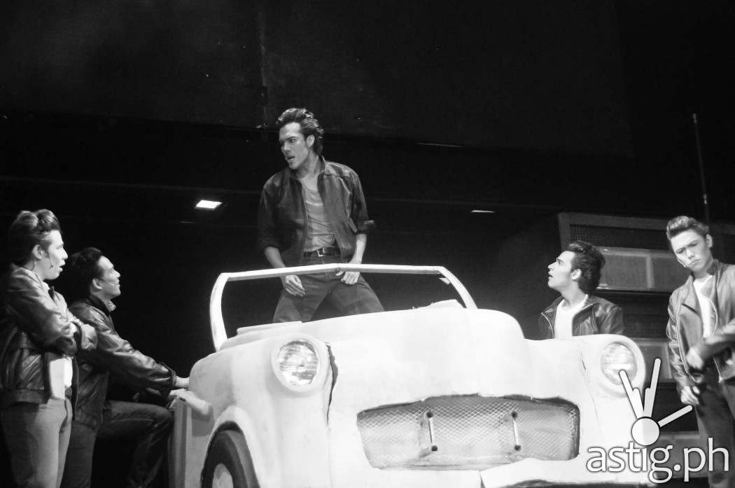 Rafa Siguion-Reyna plays the tough-looking right-hand man Kenickie - Grease by 9 Works Theatrical