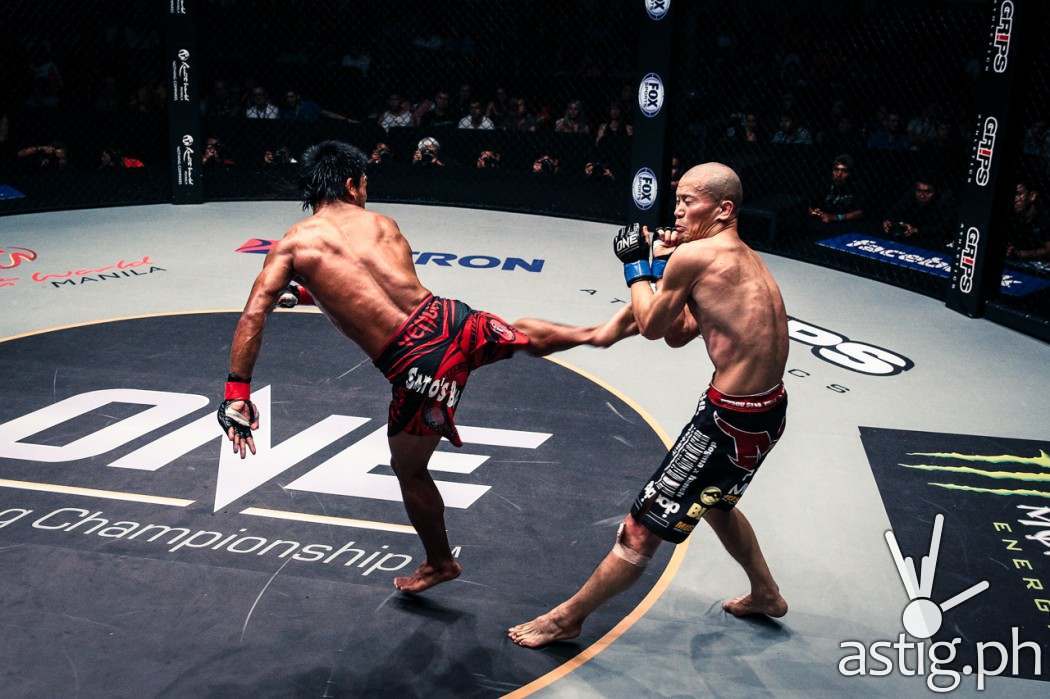 Kevin Belingon from the Philippines delivers a spinning back kick, winning via unanimous decision over Koetsu Okazaki from Japan