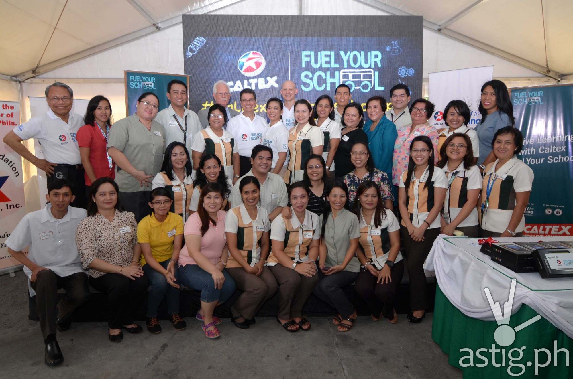 FUELLING EDUCATORS. 27 beneficiary teachers now equipped with Caltex Fuel Your School STEM tools to fuel learning for their students. Joining them are (L-R standing row) Peter Morris (9th), General Manager for Philippine Products, Chevron Philippines Inc. (CPI); Raissa Bautista (8th), Manager for Policy, Government, and Public Affairs, CPI; Edwin Feist (7th), President, American Chamber Foundation Philippines Inc. (ACF); Ebb Hinchcliffe (6th), Executive Director, American Chamber of Commerce and Jun Salipsip (1st), Executive Director, ACF; and Dr. Luz Almeda (14th), Department of Education NCR Director.
