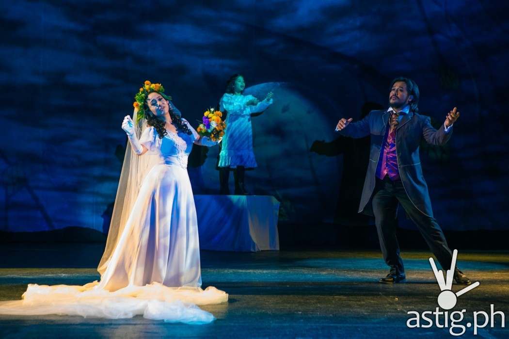 Mary Lennox (Ashlee Factor,) stands in the background, as Archibald Craven (Lorenz Martinez,) is recalling memories of his late wife, Lily (Myramae Menese