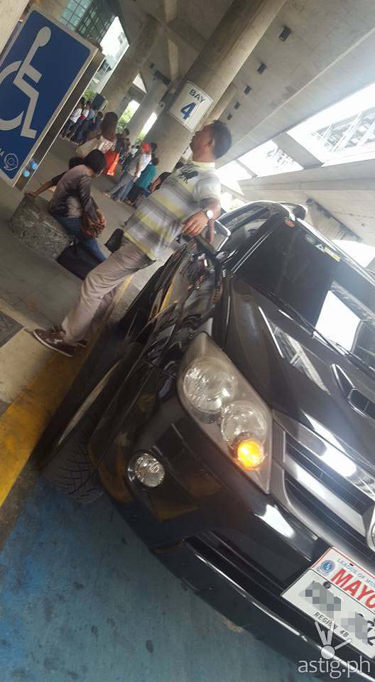 A dark man emerged from the driver side and proceeded to move the "PWD" sign