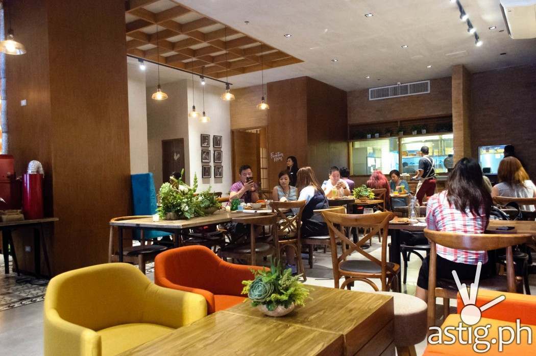 Well crafted wood furniture bring a rustic, homely feel to Café Enye