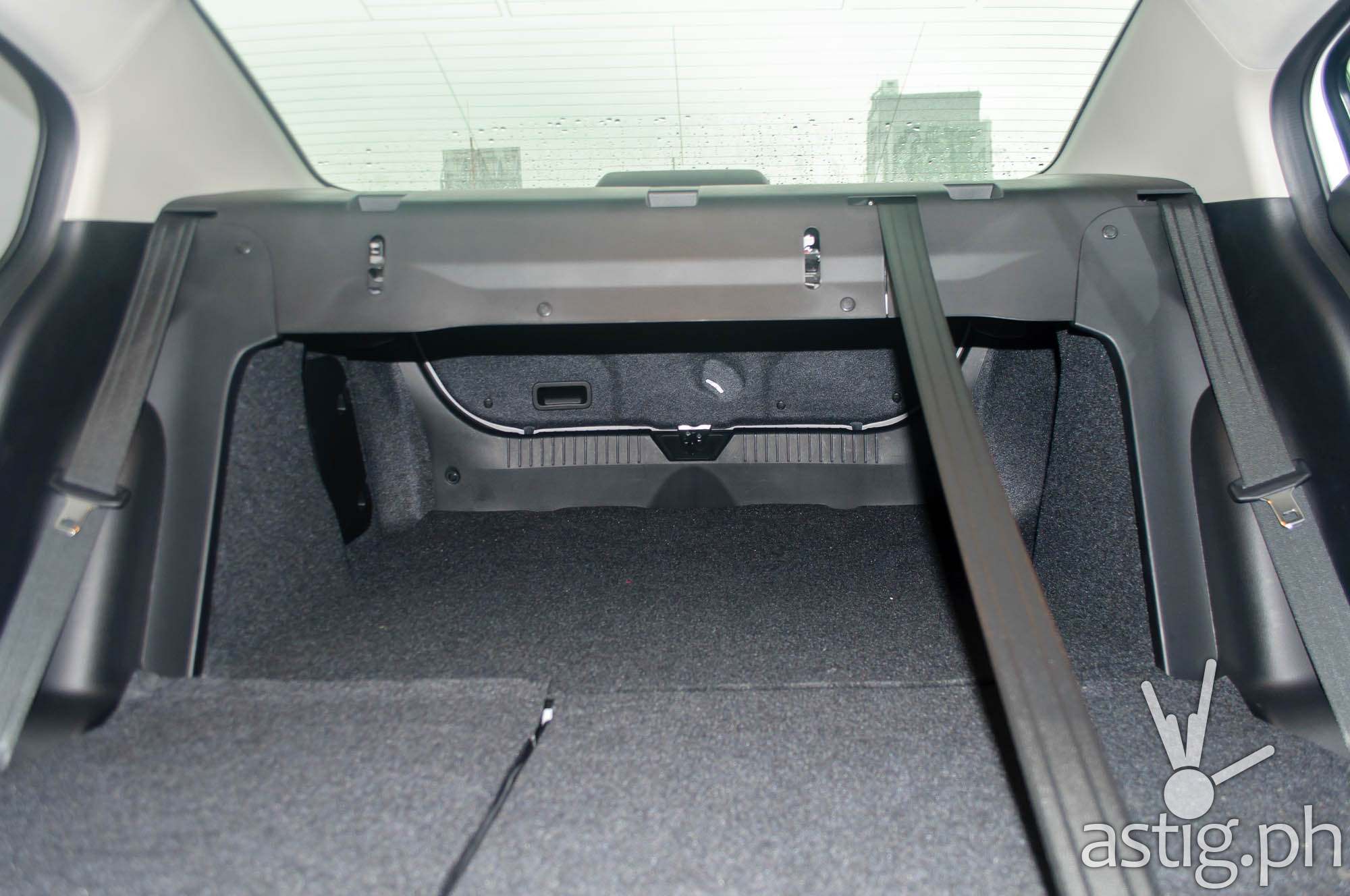Inside shot showing the extended storage space on the Mazda3 Sedan with the rear seats folded down