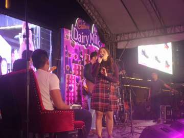 Moira serenading the newly engaged couple