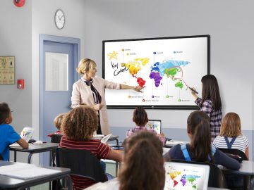 Teacher with tablet in front of elementary school class