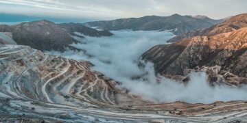 brown and white mountains under white clouds and blue sky during daytime