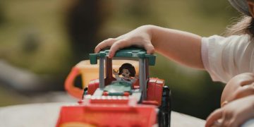 a small child playing with a toy truck