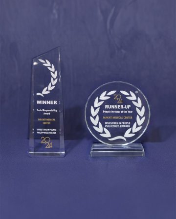 A pair of trophies on a table Description automatically generated